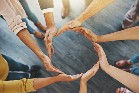 People joining hands in the circle